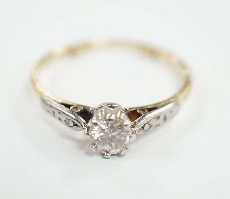 An 18ct, plat and single stone diamond set ring, with diamond chip set shoulders, size O/P, gross weight 2.5 grams. Condition - poor to fair